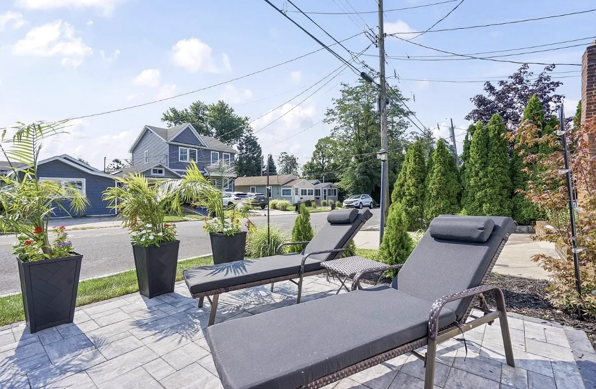 Paver patio with two loungers and planters